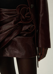 Draped leather mini skirt in burgundy